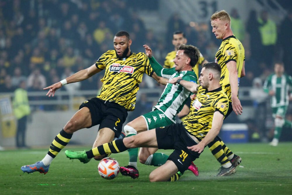 players of aek football club in a match with panathinaikos