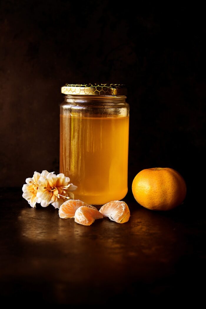 clear glass bottle with honey